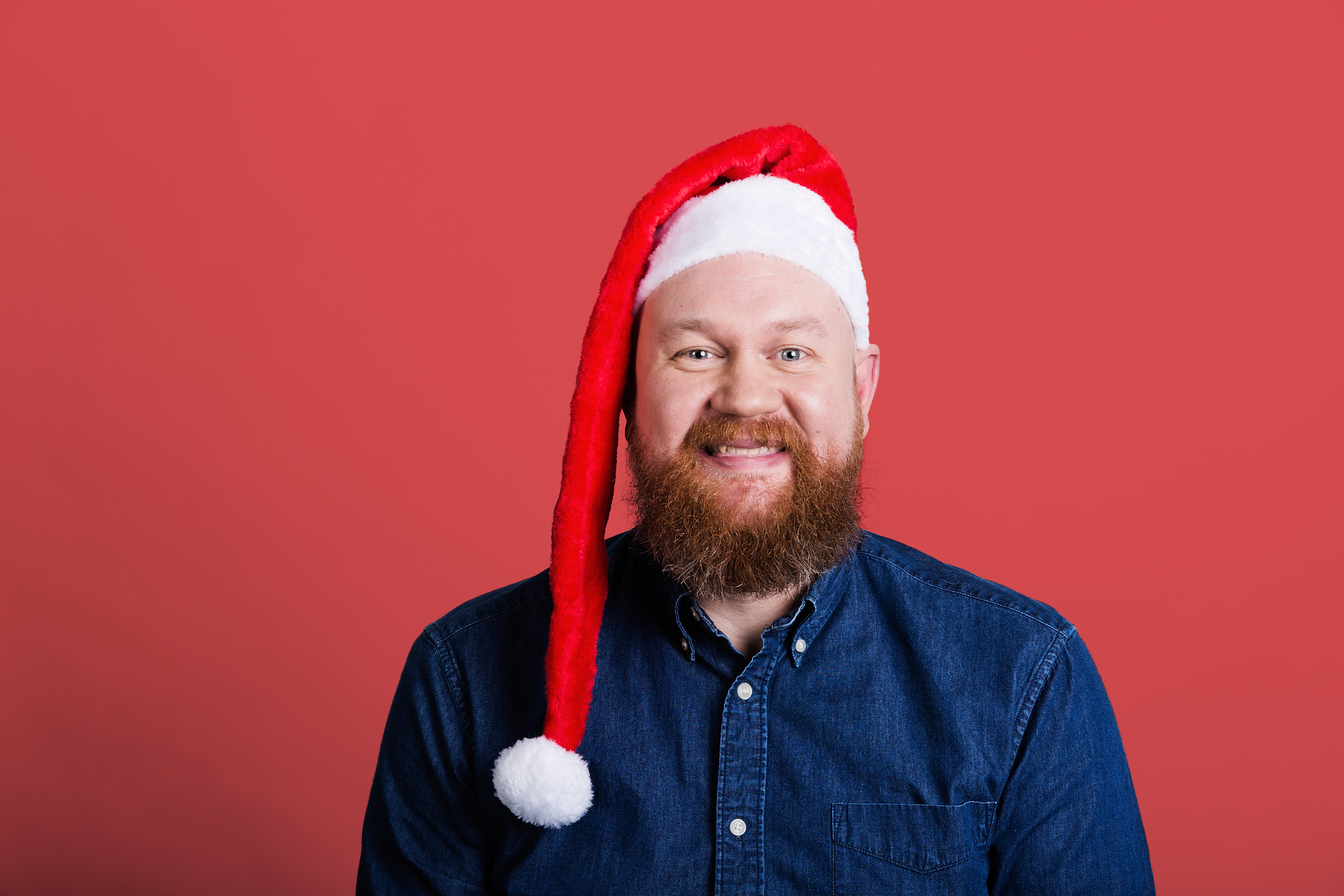 man smiling with red hat