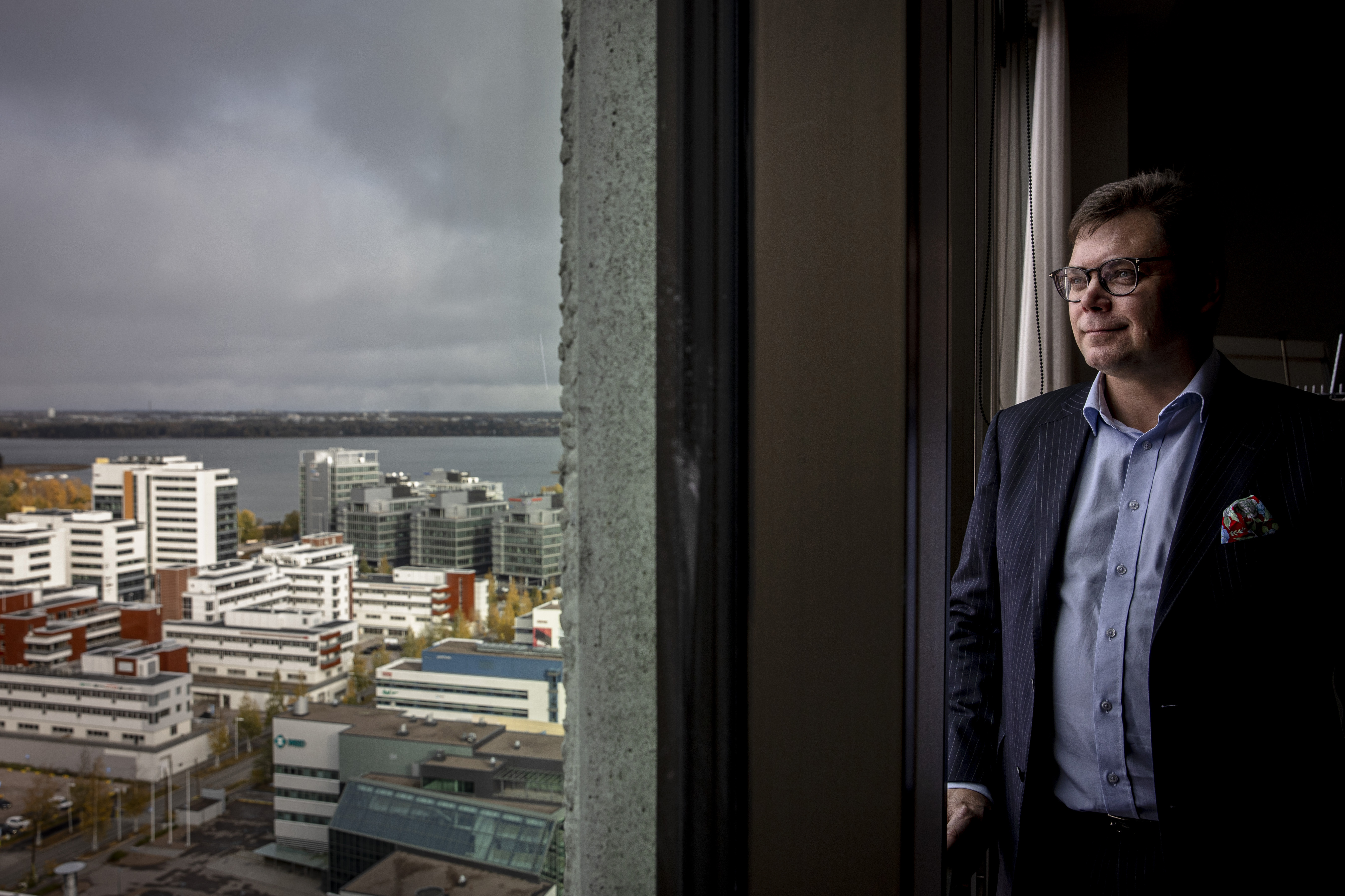 man looking out from window