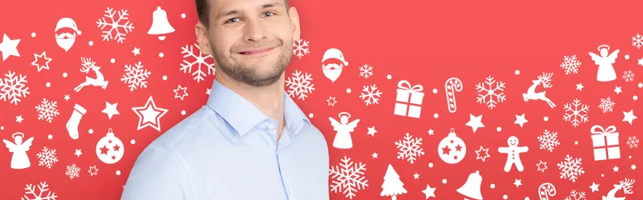 man smiling with red winter background