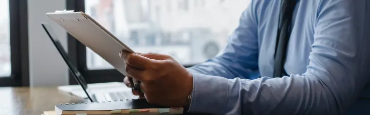 Man sitting on his ipad at a desk 