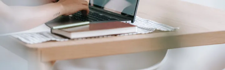 Photo by Teona Swift: https://www.pexels.com/photo/unrecognizable-worker-typing-on-laptop-at-table-with-flowers-6913825/