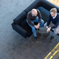 Two men looking at laptop