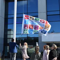 People raising a flag